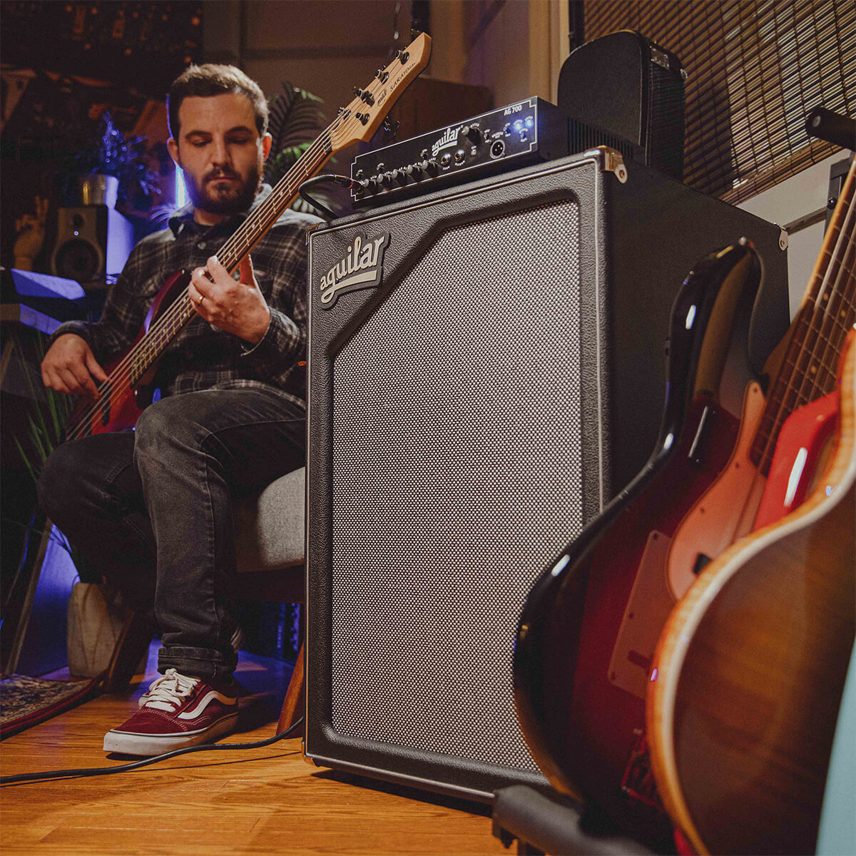 Aguilar Amp SL-1 with man strumming the guitar